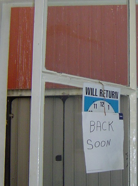 door with back soon sign